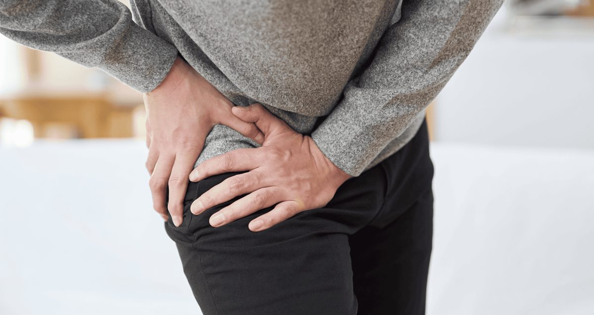 Orthopedist examining a patient's hip to distinguish hip bursitis from hip arthritis in Delray Beach