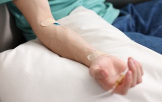Physician reviewing a patient chart before an intravenous infusion at an orthopedic practice in Delray Beach