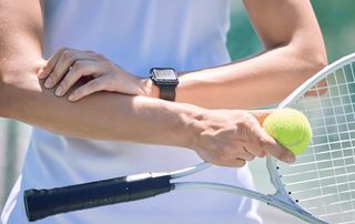 Orthopedic provider applying shockwave therapy to a patient's tendon in a Delray Beach office