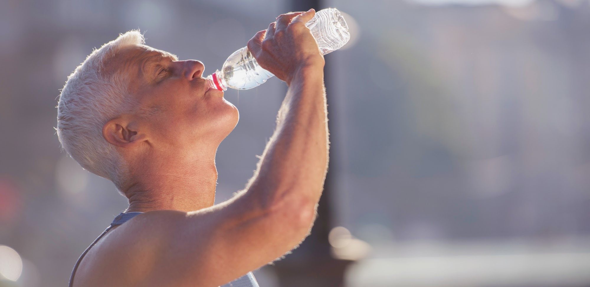 senior jogging man drinking fresh water from bottle TOSM-Blog-Identification-and-treatment-of-heat